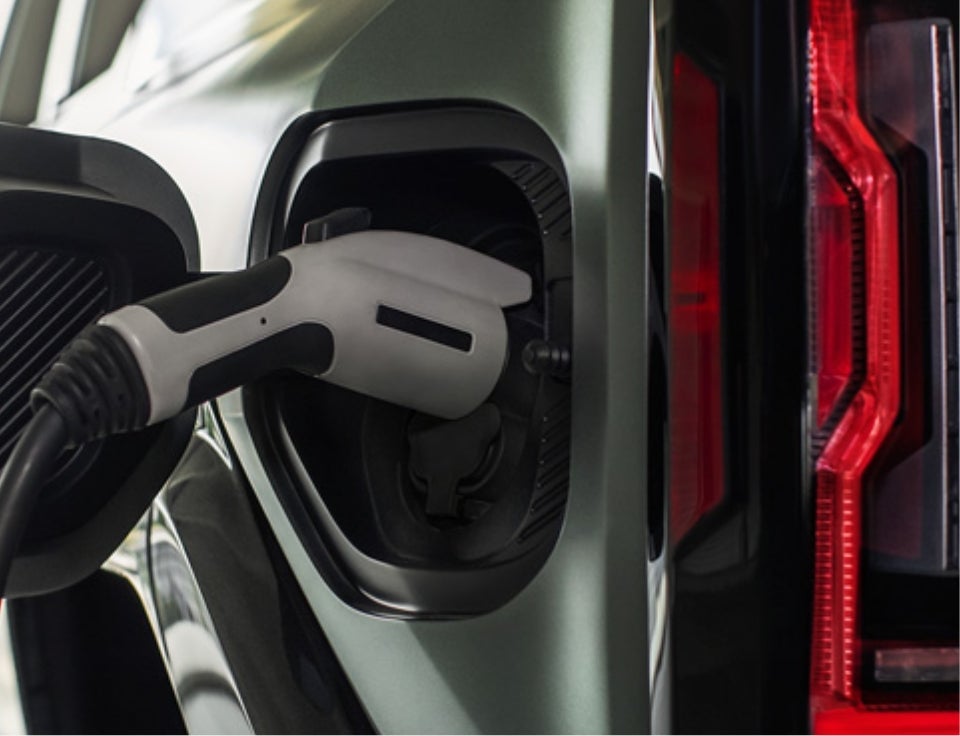 Close up of charging port with charger plugged in on a GMC Hummer EV SUV - Moses GMC of Huntington in Huntington WV